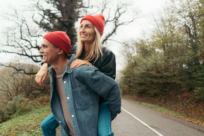 Young loving couple are fooling around outside.