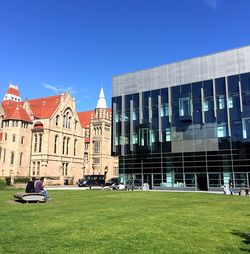 View of buildings against clear blue sky