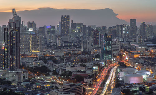 High angle view of illuminated cityscape against sky during sunset