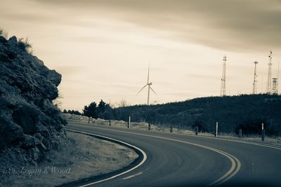 Road passing through landscape against sky