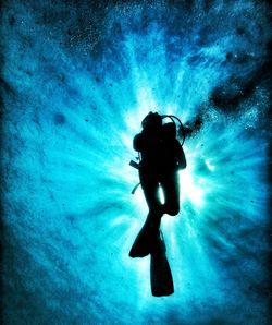 Low angle view of person scuba diving underwater