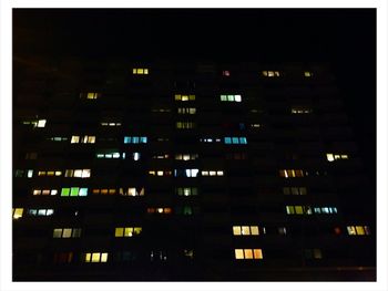 Low angle view of apartment building at night