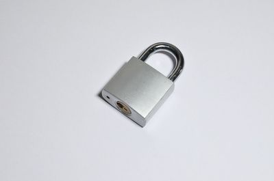High angle view of padlock on white background