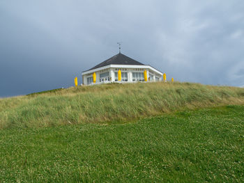 House on field against sky