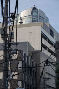 The city of roppongi 4-chome, tokyo. utility poles, electric wires and buildings are lined up.