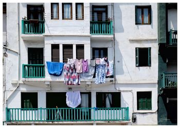 Façade with drying clothes hanging outside the window.