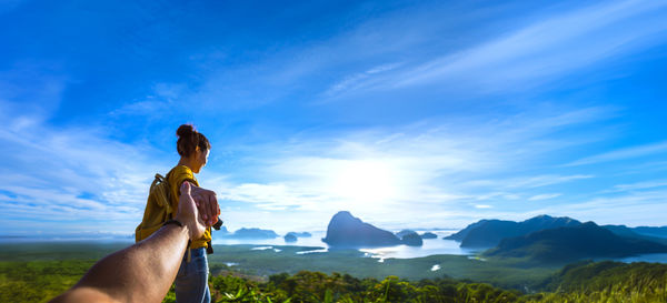 Rear view of woman standing against mountain