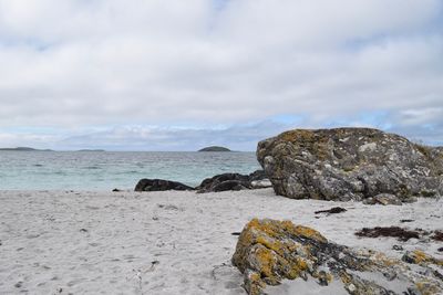 Rocks on beach against sky