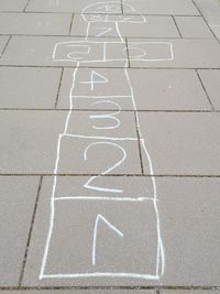 High angle view of text on footpath