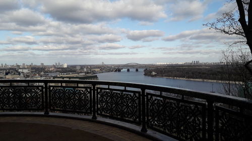 Bridge over river in city against sky