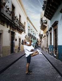 A couple in the streets of a colorful town in mexico.