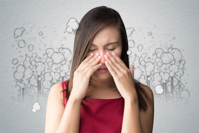 Beautiful woman with sinus pain over white background