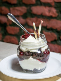 Close-up of dessert in jar on table