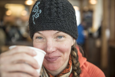 A woman enjoys a cup of tea in a lodge at the mount baker ski area.