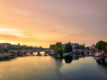 Bridge over river against buildings in city