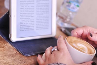 Midsection of woman holding coffee cup