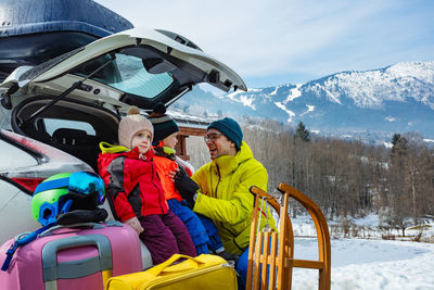 Rear view of man riding on snow covered mountain