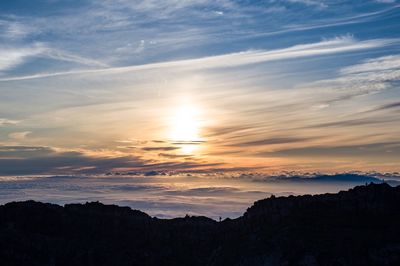 Scenic view of silhouette mountains against sky during sunset