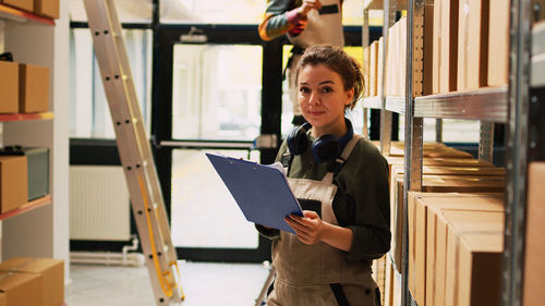 Portrait of young woman using digital tablet in office