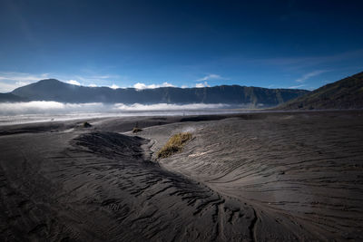 Scenic view of volcanic sand dune against sky