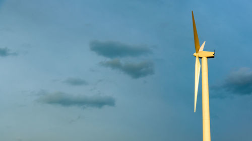 Low angle view of wind turbine against sky