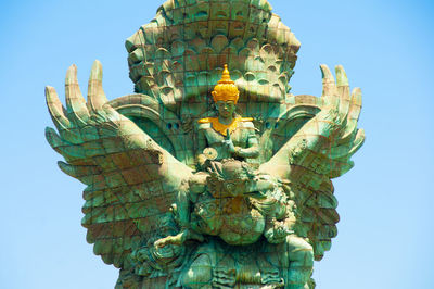 Low angle view of statue against sky