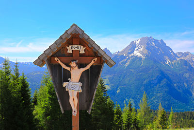 Crucifix against mountain range