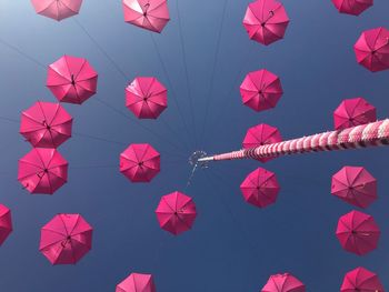 Low angle view of lanterns hanging against sky