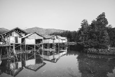 Houses by lake against sky