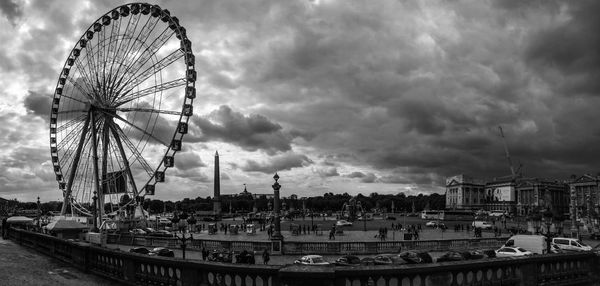 Ferris wheel against cloudy sky