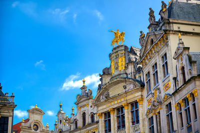 Low angle view of buildings against blue sky