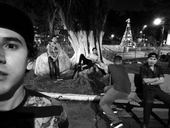 Portrait of young couple sitting at night