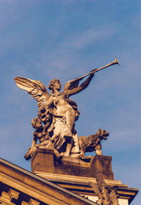 Low angle view of statues on top of hessisches staatstheater wiesbaden