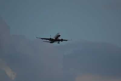 Low angle view of airplane flying in sky