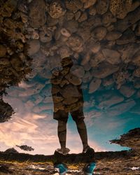 Low section of man standing on rock