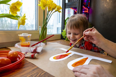 Close-up of boy eating food at home