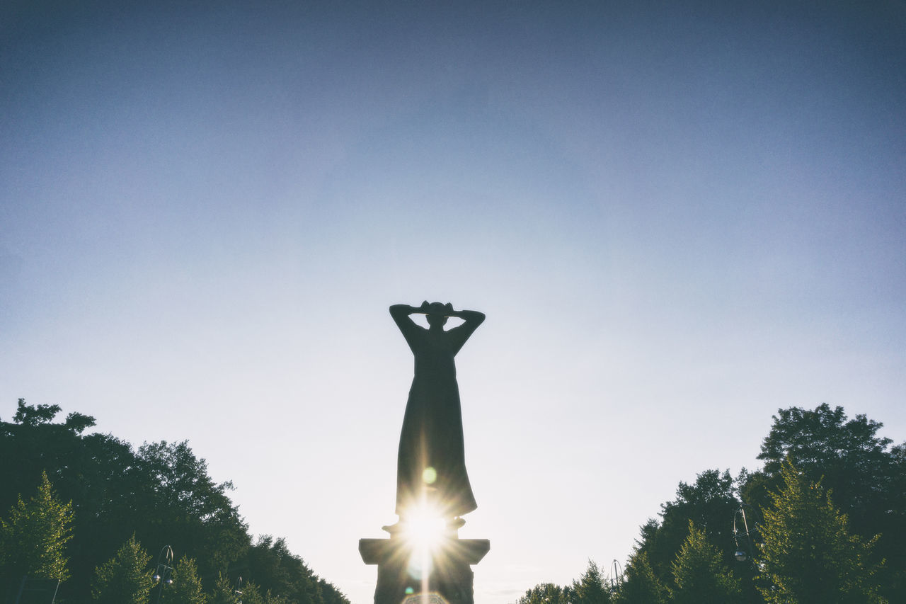 LOW ANGLE VIEW OF STATUES AGAINST SKY