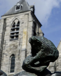 Low angle view of statue against building