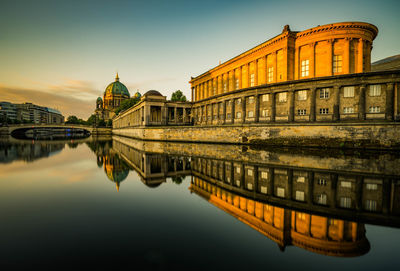 Reflection of building on water in city