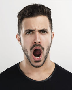 Portrait of young man against white background