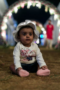 Portrait of cute baby girl in illuminated hat