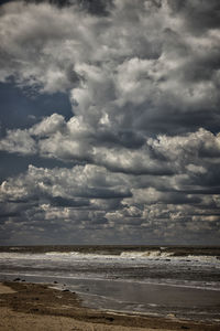 Scenic view of sea against cloudy sky