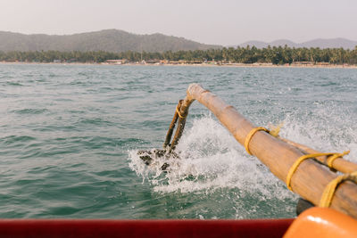 Man splashing water in sea against sky