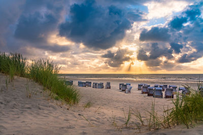 Scenic view of beach against sky during sunset