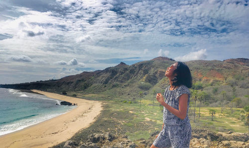 Woman standing on land against sky