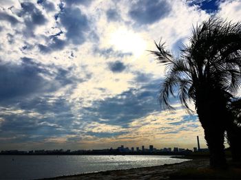 Scenic view of river against cloudy sky