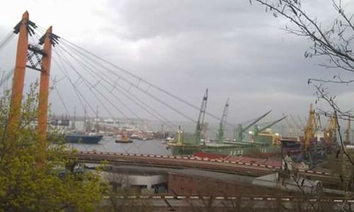 Bridge over river against cloudy sky