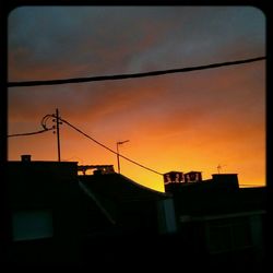 Low angle view of building against sky at sunset