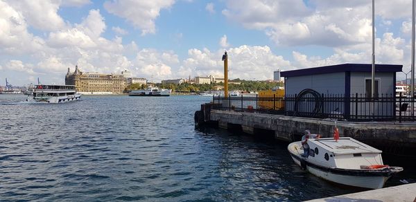 Nautical vessel on sea against sky in city