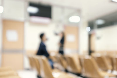 Defocused image of people walking on table in building